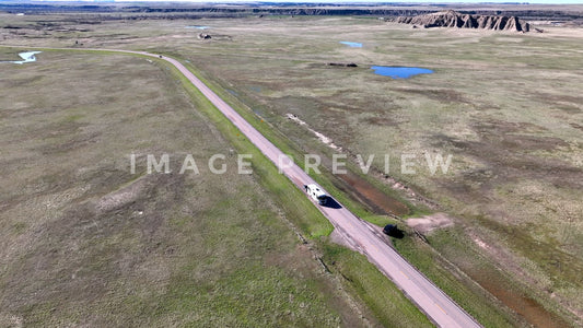 4k Still Frame - Badlands, South Dakota RV traveling past button on mixed-grass prairie