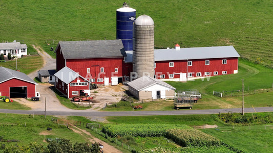 stock photo Farmhouse with red barn and silos in New York State