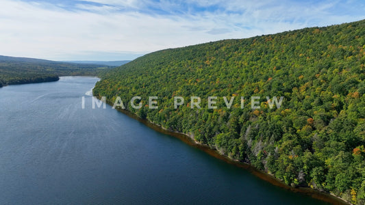 4k Still Frame - Canadice Lake, NY Finger Lake hillside trees in early Autumn color