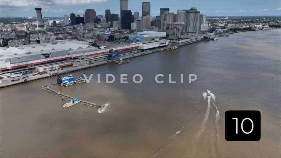 CLIP 10 - New Orleans, LA Vol. 1 - boat motoring towards downtown as Mississippi river is being dredged