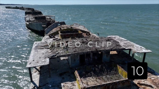 CLIP 10 - Kiptopeke Concrete Ships, VA low flight over top as sun shines on water