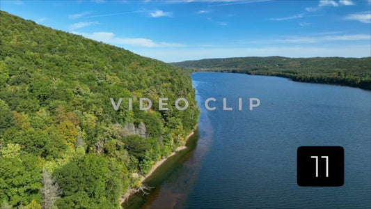 CLIP 11 - Canadice Lake, NY Finger Lake beside green hillside in early Fall season