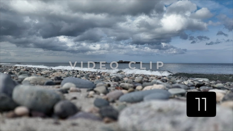 CLIP 11 - View from beach of Island in ocean beneath overcast cast clouds