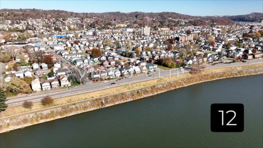 CLIP 12 - Charleston, WV birds flying over bridge with neighborhood homes by river