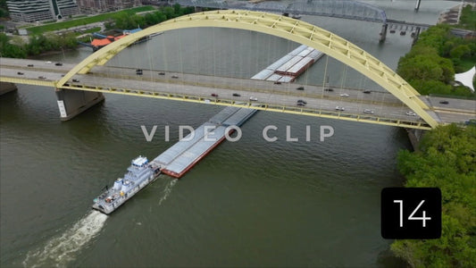 CLIP 14 - Cincinnati, Ohio tugboat pushing barges under arched bridge on Ohio river