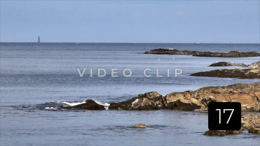 CLIP 17 - 7x zoom Boston, Ma rocky coastline with lighthouse on horizon
