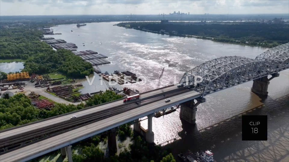 CLIP 18 - New Orleans, LA morning light on Mississippi River as traffic crosses Huey P. Long Bridge