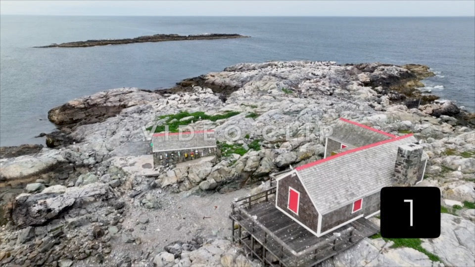 CLIP 1 - Low flight over rocky island with wildlife in Massachusetts Bay