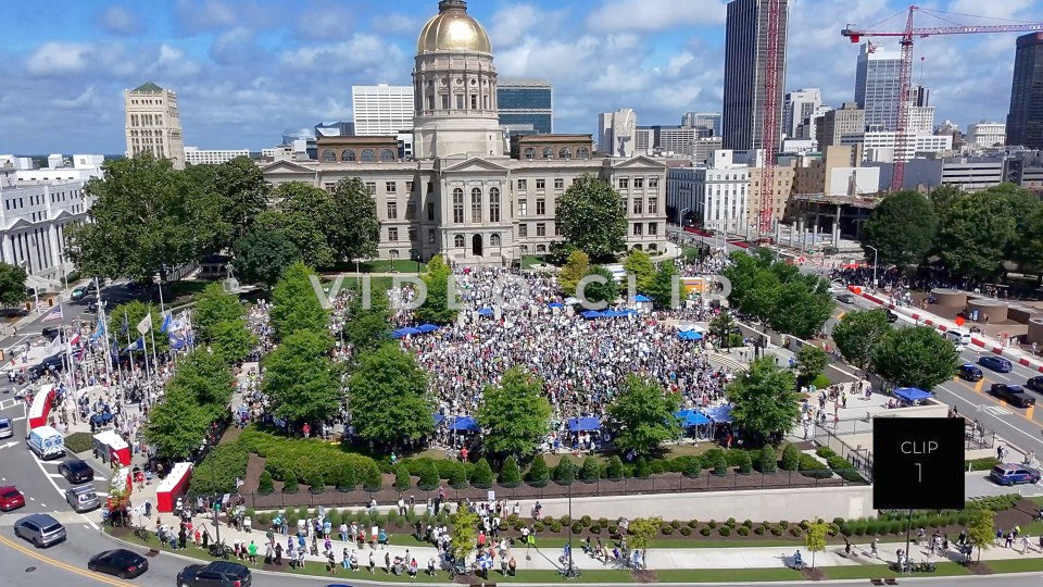 CLIP 1 - Atlanta, GA No Kings Protest - Aerial flight to Georgia State Capitol as camera tilts down to protesters