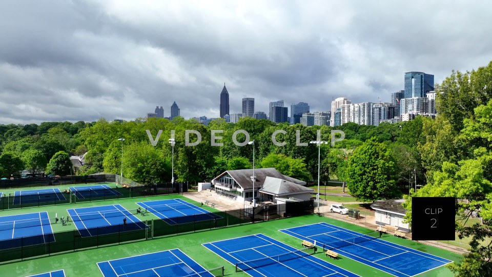 CLIP 2 - Atlanta, GA Aerial rising up over Tennis courts to city skyline from Piedmont Park