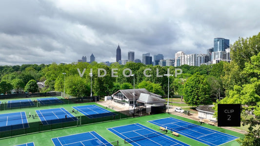 CLIP 2 - Atlanta, GA Aerial rising up over Tennis courts to city skyline from Piedmont Park