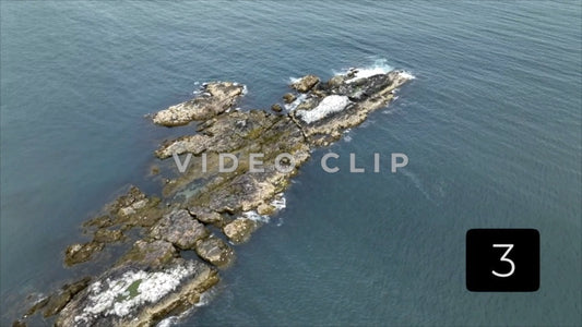 CLIP 3 - Aerial view of rocky island in calm water off the coast of Massachusetts