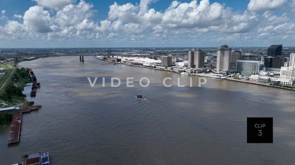 CLIP 3 - New Orleans, LA tug boat motoring up Mississippi River past downtown