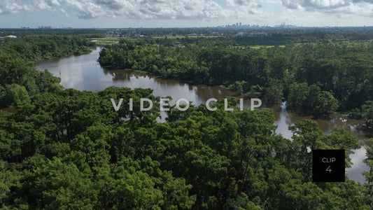 CLIP 4 - New Orleans, LA Segnette bayou tree top flying with city skyline in distance