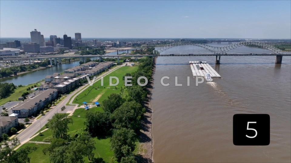 CLIP 5 - Memphis, TN city skyline with Boat pushing barges on Mississippi River