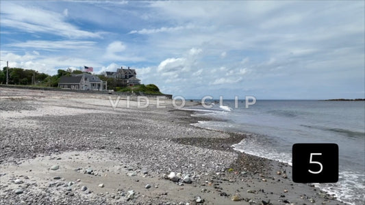 CLIP 5 - Boston, MA gentle flight down pebble beach towards house with American Flag
