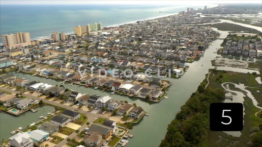CLIP 5 - Cherry Grove Beach, SC flying over vacation beach houses and homes by the tidal marsh