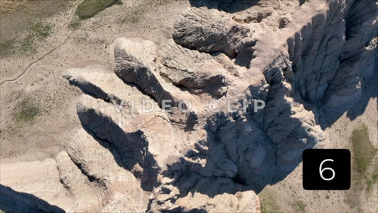 CLIP 6 - Badlands, SD flying over top of Butte while looking down on formations