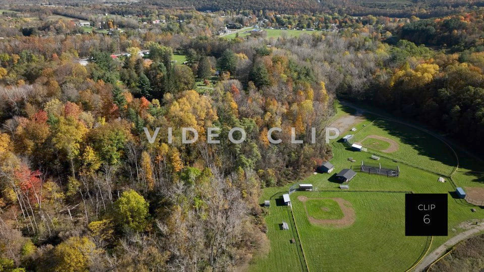 CLIP 6 - Tioga-Hammond Lakes, PA rising over green park with baseball field to view Tioga, GA