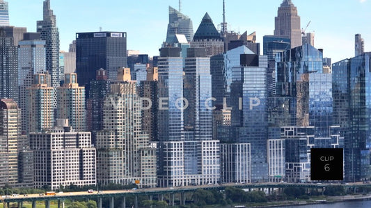 CLIP 6 - New York, NY Telephoto view of glass office towers with cars driving by along Hudson River