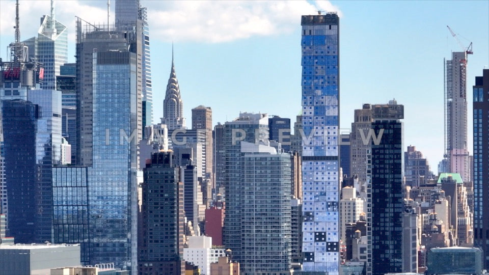 Photo - New York City, NY Glass buildings reflecting blue sky