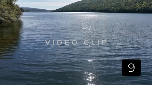 CLIP 9 - Canadice Lake, NY low flight over peaceful Finger Lake with sunlight