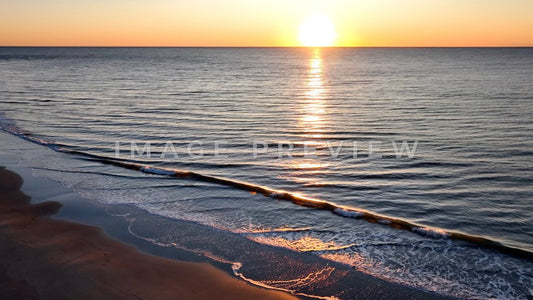 4k Still Frame - Pawleys Island, SC sunrise at the beach with sunlight on waves