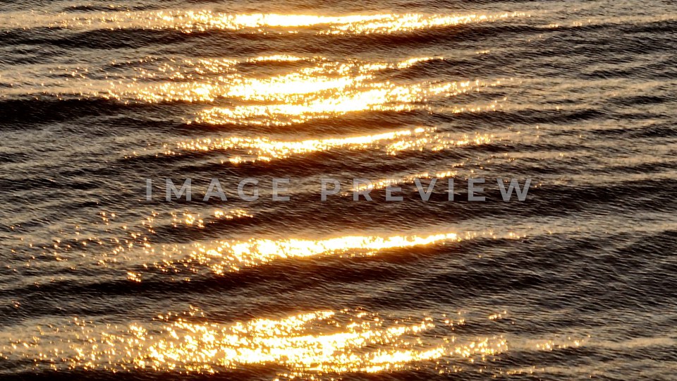 4k Still Frame - Pawleys Island, SC sunrise at beach as warm sunlight shines on ocean waves