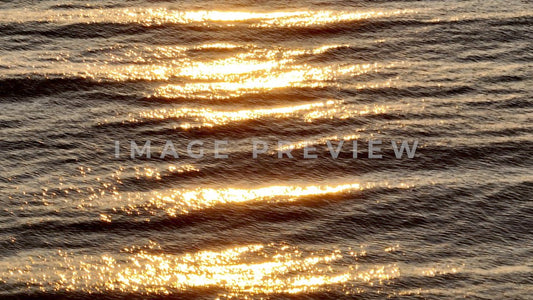 4k Still Frame - Pawleys Island, SC sunrise at beach as warm sunlight shines on ocean waves