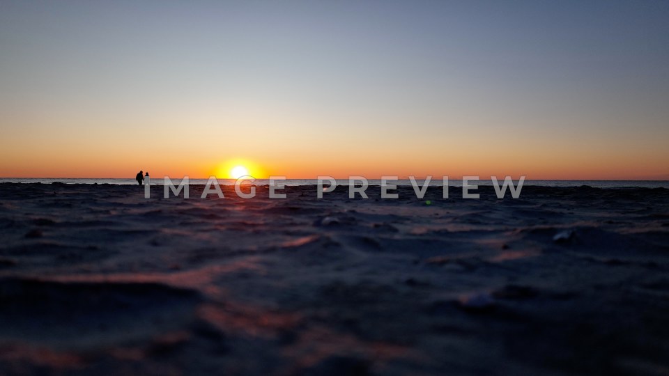 4k Still Frame - Pawleys Island, SC sunrise on the beach with couple walking