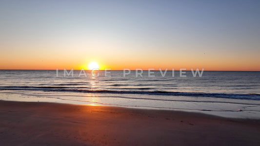 4k Still Frame - Pawleys Island, SC sunrise on the beach with gentle ocean surf