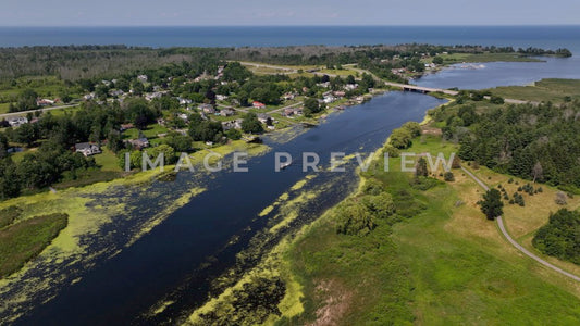 4k Still Frame - Braddock Bay, NY river flowing into Lake Ontario past wetlands and homes
