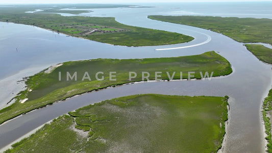 4k Still Frame - McClellanville, SC boat motors through inlet past tidal marshland to Intracoastal Waterway