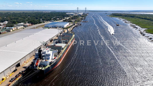 Brunswick, GA boats motoring by cargo ship docked at Georgia Ports Authority