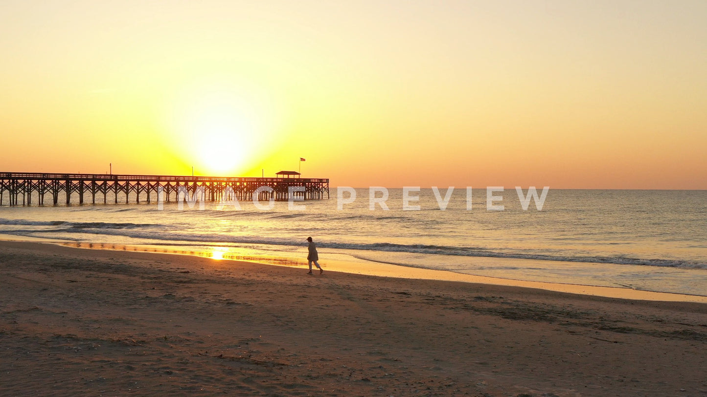 stock photo sunrise beach walker by pier