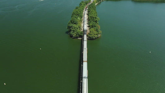 Video - Transportation by Train of goods in shipping containers over West Point Reservoir Lake in Georgia