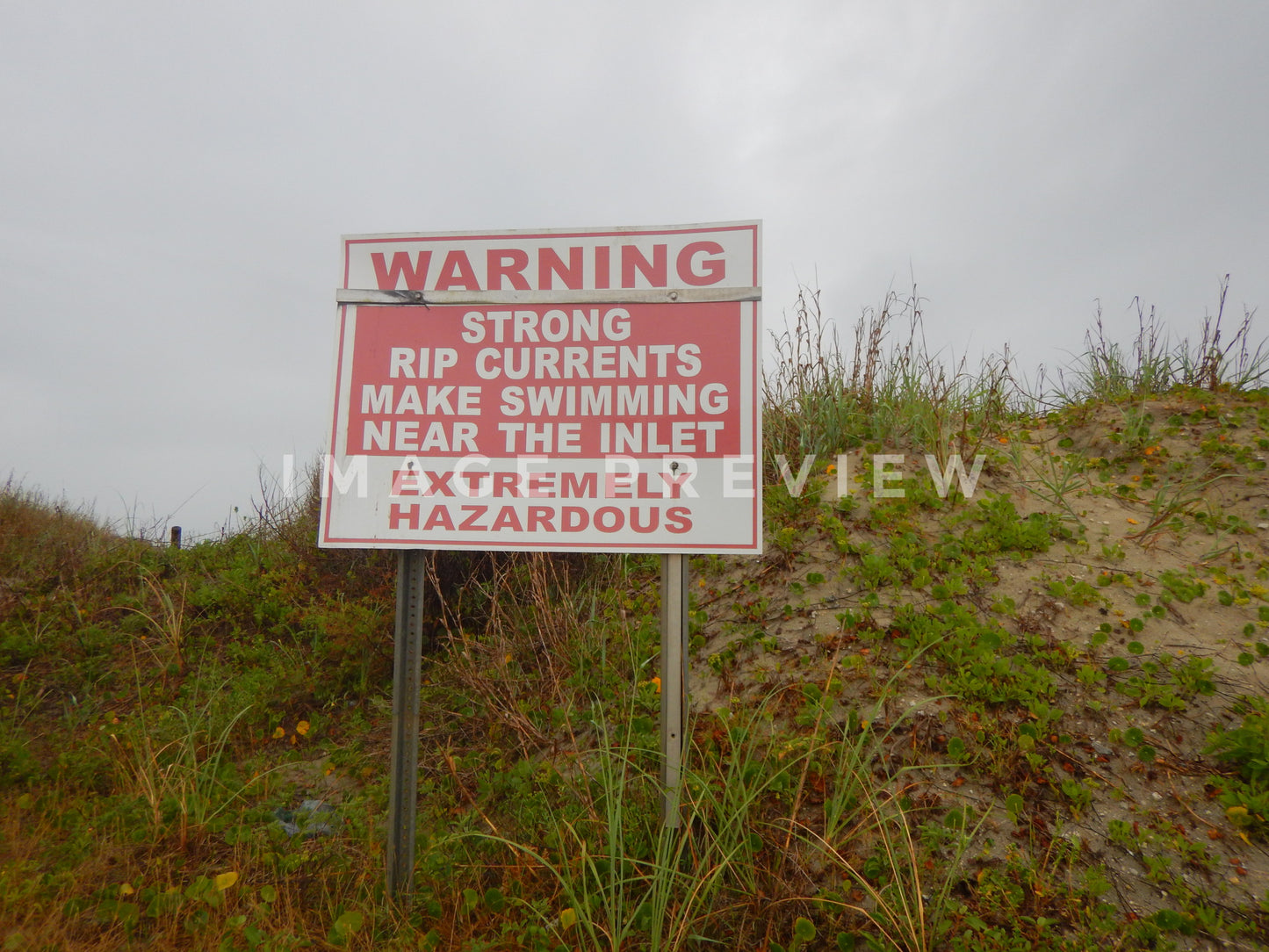 Photo - Warning sign at the beach as storm approaches