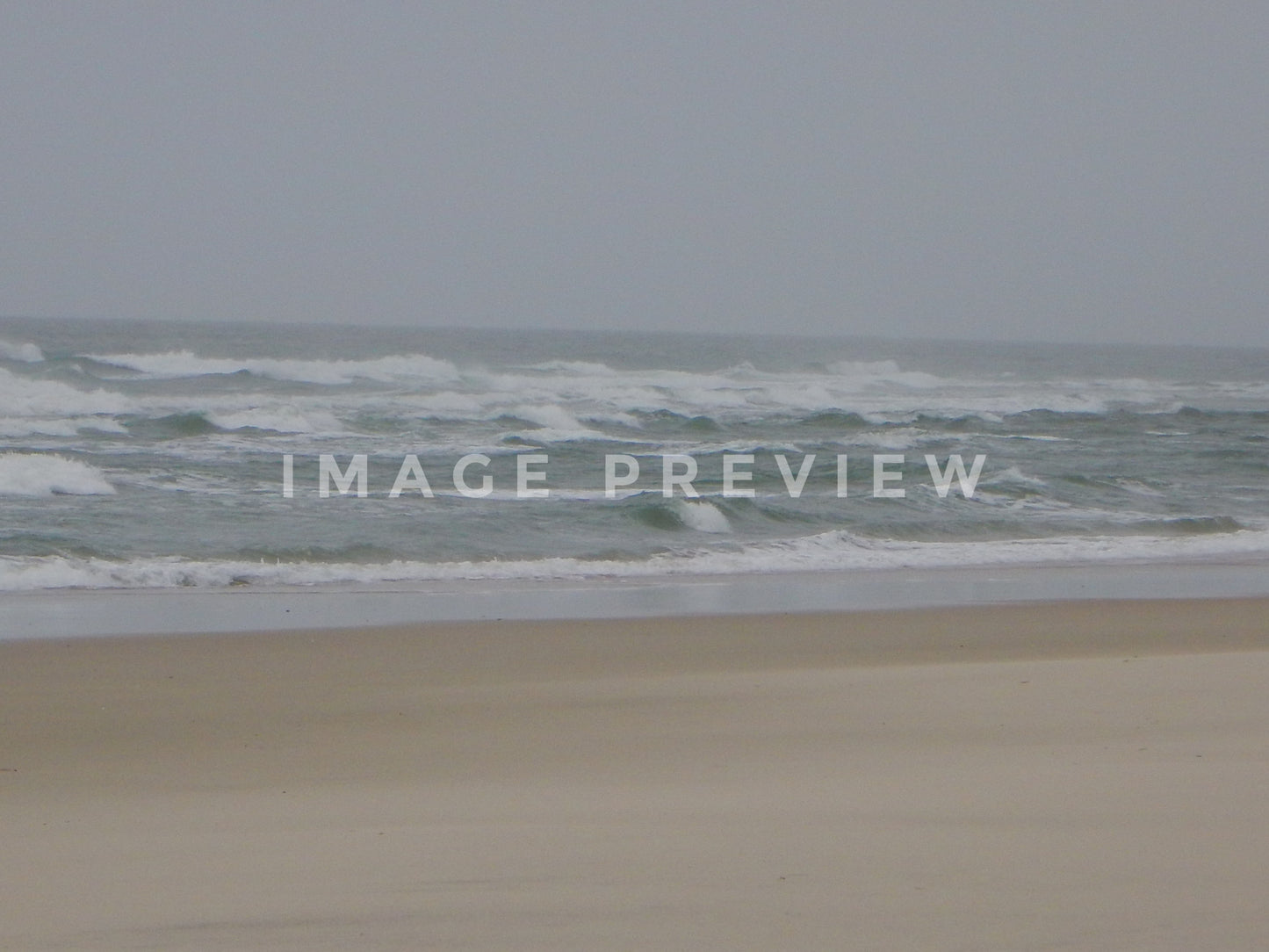 Photo - Ocean with rough waves under stormy skies at beach