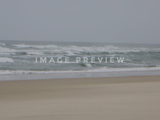 Photo - Ocean with rough waves under stormy skies at beach