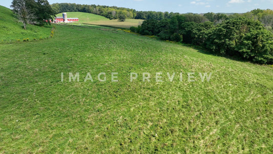 stock photo Landscape with green pasture and farmhouse in distance