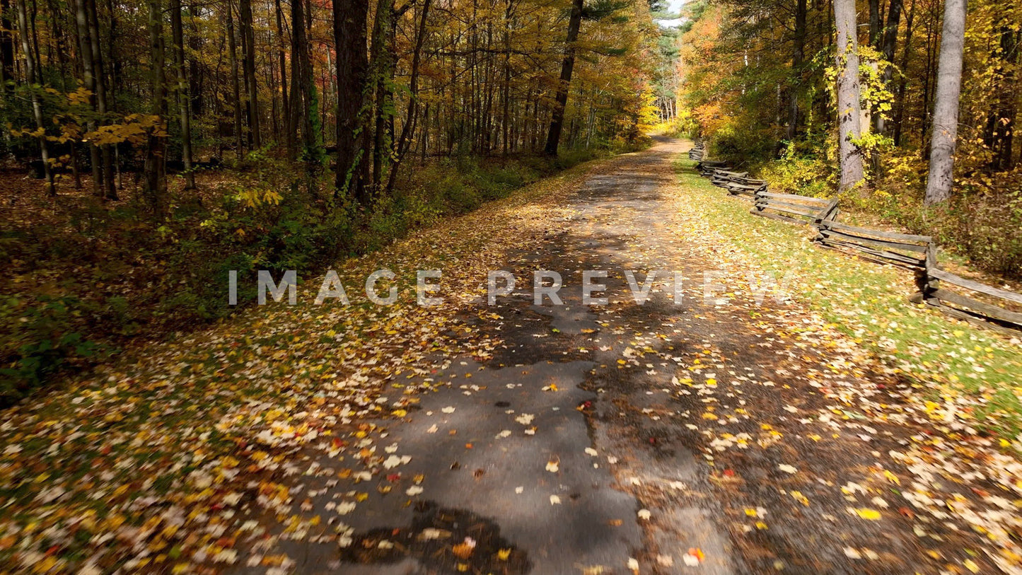 4k Still Frame - Traveling down country road during Fall season with old wood fence