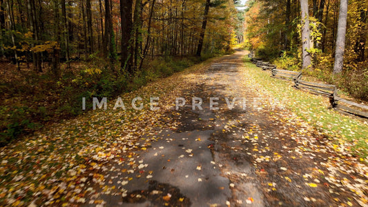 4k Still Frame - Traveling down country road during Fall season with old wood fence