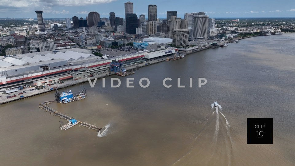 CLIP 10 - New Orleans, LA boat motoring towards downtown as Mississippi river is being dredged