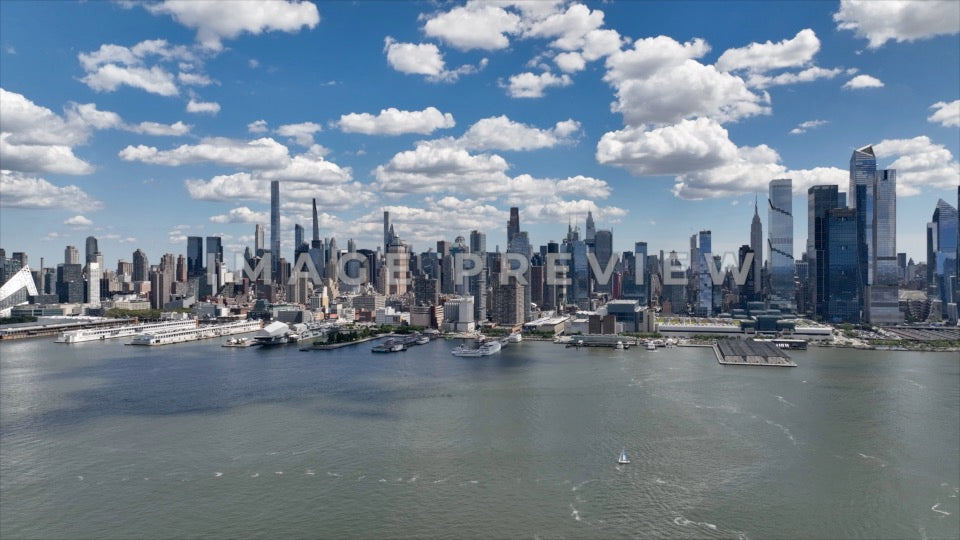 Photo - New York City, NY Beautiful blue sky and clouds over city skyline along Hudson River