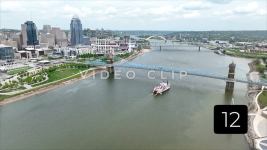 CLIP 12 - Cincinnati, Ohio aerial landscape with city skyline, Ohio river and riverboat passing under bridge