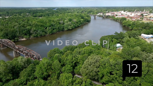 CLIP 12 - Selma, AL slow turn over trees with view of train crossing Alabama River with city on horizon