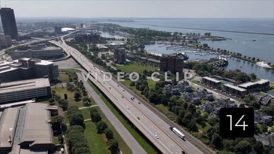 CLIP 14 - Buffalo, NY drone flight over interstate highway with cars traveling past Lake Erie