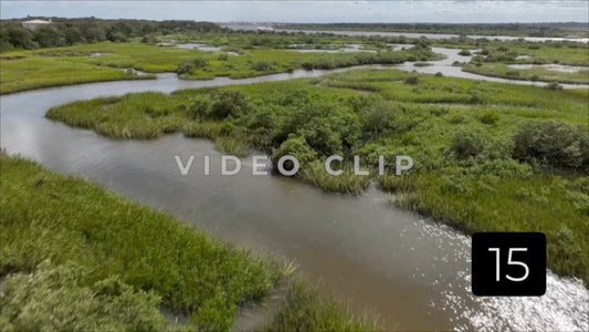 CLIP 15 - St Augustine, Florida low flight over tidal marsh with sunlight on water