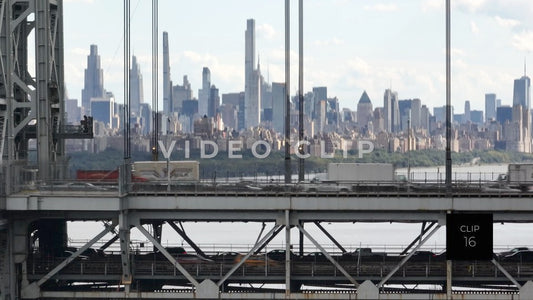 CLIP 16 - New York, NY close view of George Washington Bridge with traffic and biker