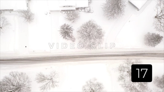 CLIP 17 - Winter Vol. 4 - Homes and street in Winter snow as car passes by